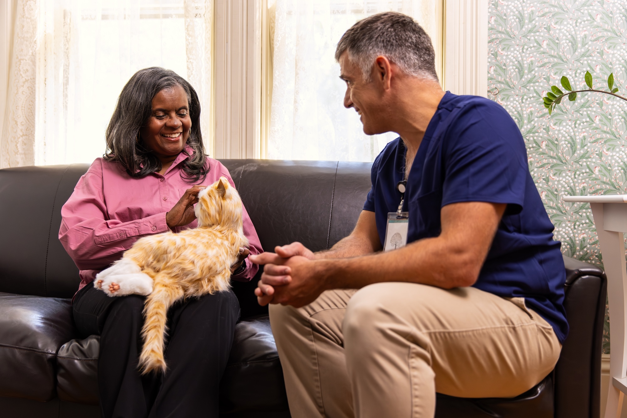 Exploring the Effects of Interaction with a Robot Cat for Dementia Sufferers and their Carers